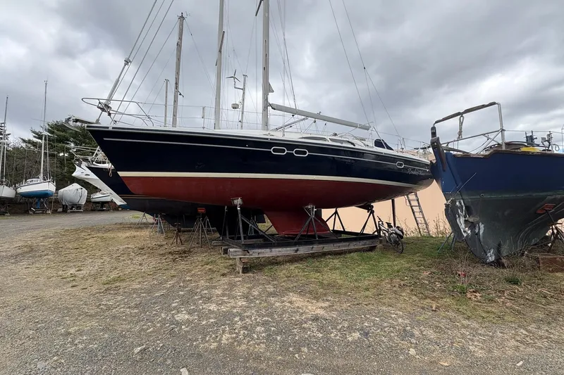 Rendez-vous Yacht Photos Pics 2003 Catalina 387 sailboat on land, surrounded by other boats, under cloudy skies.