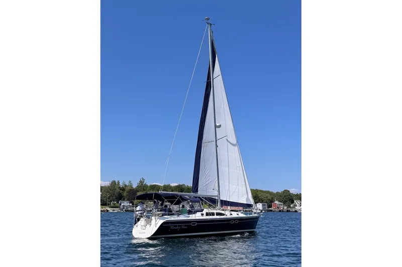 Rendez-vous Yacht Photos Pics Sailboat Catalina 387, 2003 model, cruising on a sunny day with clear blue skies.