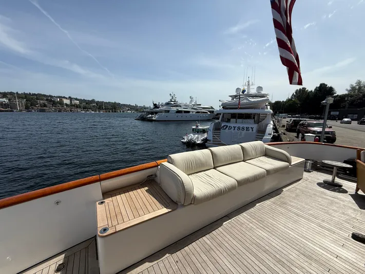 Arrivederci IV Yacht Photos Pics Luxurious 1998 Cantieri di Pisa AKHIR yacht deck with waterfront view and American flag.