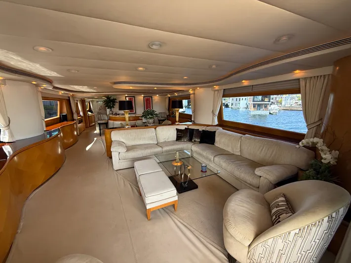 Arrivederci IV Yacht Photos Pics Luxurious 1998 Cantieri di Pisa AKHIR yacht interior with elegant seating and large windows.