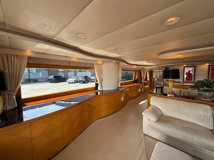 Arrivederci IV Yacht Photos Pics Luxurious interior of 1998 Cantieri di Pisa AKHIR yacht with elegant wood paneling and plush seating.