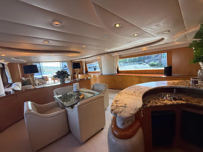 Arrivederci IV Yacht Photos Pics Luxurious interior of 1998 Cantieri di Pisa AKHIR yacht with elegant seating and granite bar.