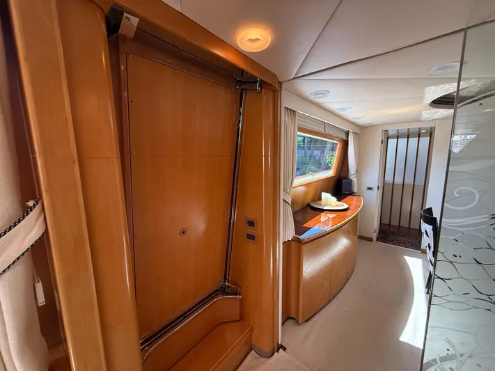 Arrivederci IV Yacht Photos Pics Luxurious interior of 1998 Cantieri di Pisa AKHIR yacht with wooden finishes and modern design.