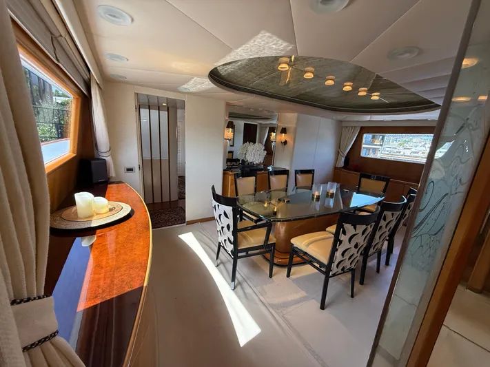Arrivederci IV Yacht Photos Pics Luxurious dining area on 1998 Cantieri di Pisa AKHIR yacht with elegant decor and ample seating.