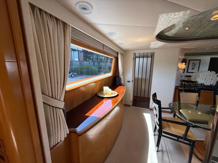 Arrivederci IV Yacht Photos Pics Luxurious interior of 1998 Cantieri di Pisa AKHIR yacht with elegant dining area and large window.