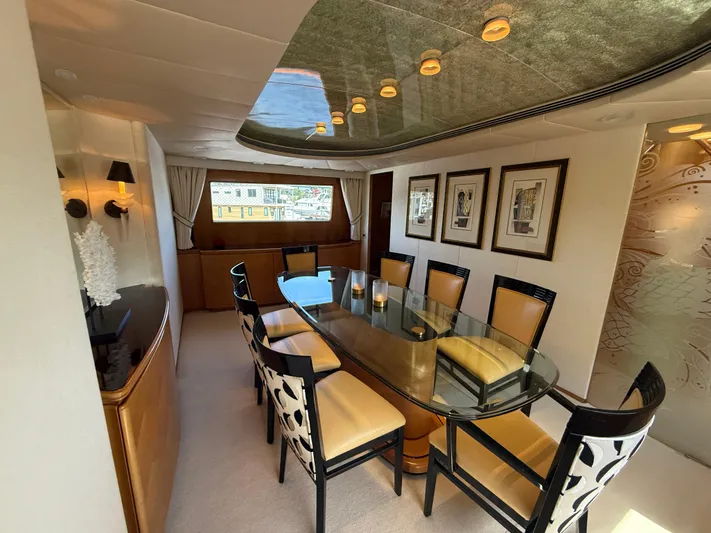 Arrivederci IV Yacht Photos Pics Luxurious dining area on 1998 Cantieri di Pisa AKHIR yacht with elegant decor and seating.