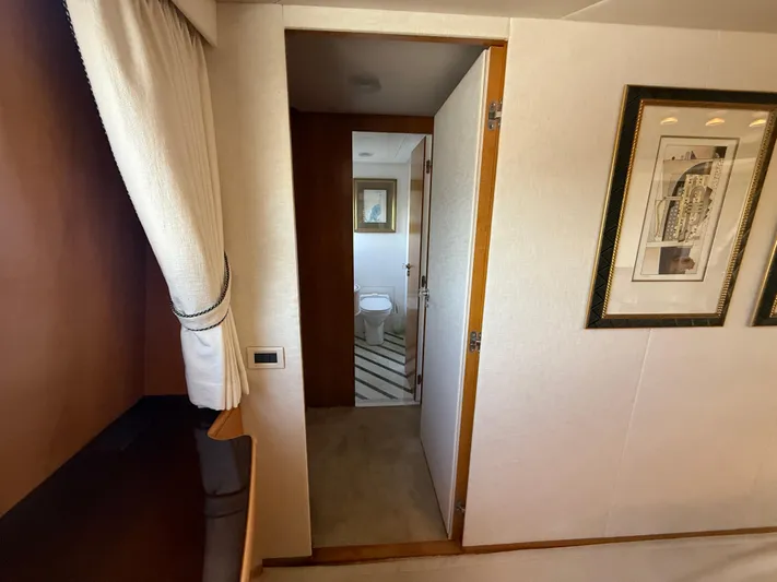 Arrivederci IV Yacht Photos Pics Interior of 1998 Cantieri di Pisa AKHIR yacht, featuring a bathroom and framed artwork.