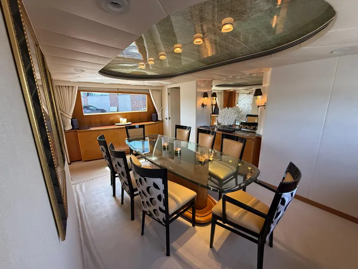 Arrivederci IV Yacht Photos Pics Luxurious dining area on 1998 Cantieri di Pisa AKHIR yacht, featuring elegant decor and seating.