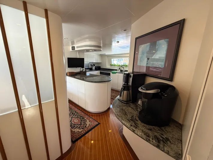 Arrivederci IV Yacht Photos Pics Luxurious kitchen interior on 1998 Cantieri di Pisa AKHIR yacht with modern appliances and elegant decor.