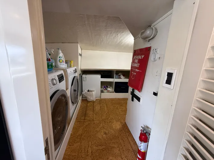 Arrivederci IV Yacht Photos Pics Laundry area on 1998 Cantieri di Pisa AKHIR yacht with washer, dryer, and storage.