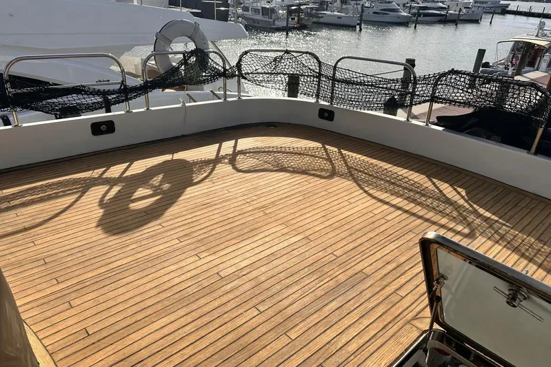 85 Azimut Ultimate Yacht Photos Pics Deck of 1999 Azimut 85 Ultimate yacht with wooden flooring and marina view.