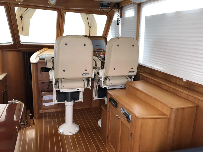 Southern Charm Yacht Photos Pics Interior of 2010 Sabre 40 Sedan with helm chairs and wooden flooring.