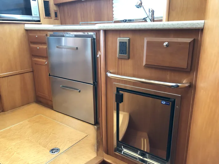 Southern Charm Yacht Photos Pics 2010 Sabre 40 Sedan kitchen with stainless steel appliances and wooden cabinetry.