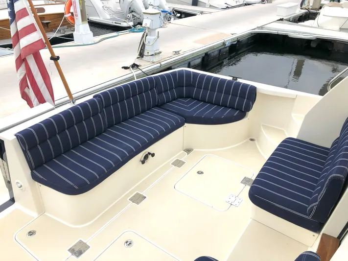Southern Charm Yacht Photos Pics 2010 Sabre 40 Sedan boat with striped seating in a marina setting.