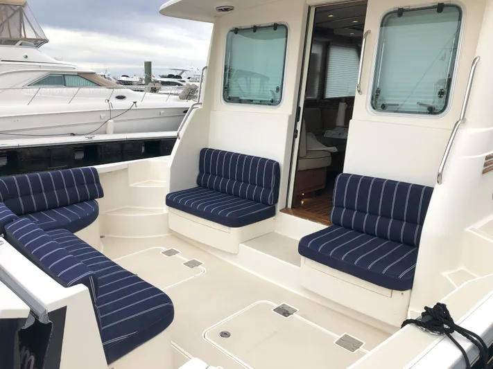 Southern Charm Yacht Photos Pics 2010 Sabre 40 Sedan boat with striped seating in a marina setting.