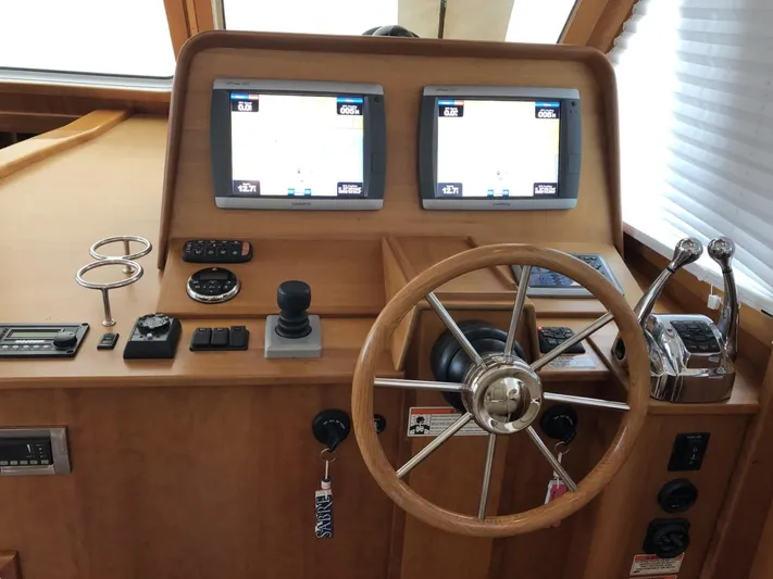 Southern Charm Yacht Photos Pics Helm of 2010 Sabre 40 Sedan with dual navigation screens and wooden steering wheel.