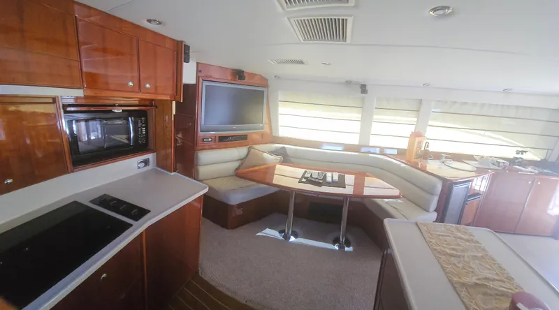 Christina Yacht Photos Pics Luxurious interior of 2004 Riviera 58 Enclosed Flybridge yacht with modern amenities.