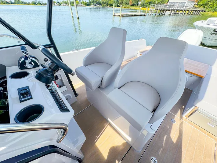 4787mm Yacht Photos Pics 2023 RYCK 280 boat interior with dual seats and control panel, docked by the water.
