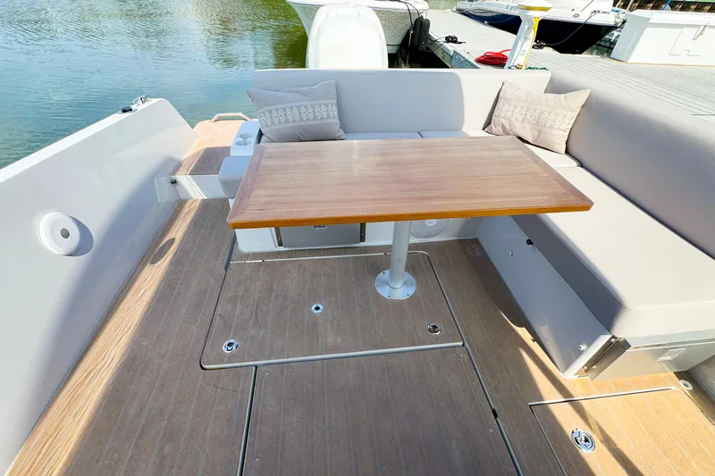 4787mm Yacht Photos Pics RYCK 280 boat interior with wooden table and cushioned seating, 2023 model.