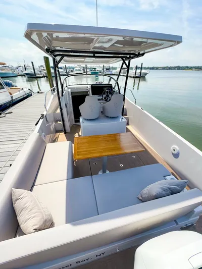 4787mm Yacht Photos Pics 2023 RYCK 280 boat with spacious seating and wooden table, docked at marina.