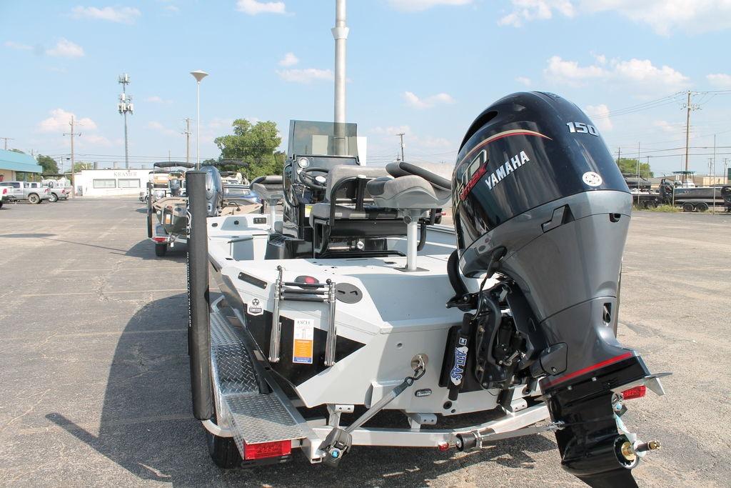 2026 Excel Bay Pro Elite 203 boat with Yamaha 150 engine in parking lot.