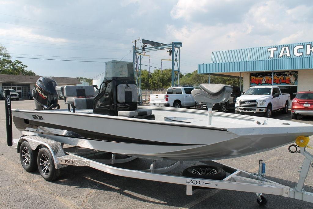2026 Excel Bay Pro Elite 203 boat on trailer outside tackle shop.