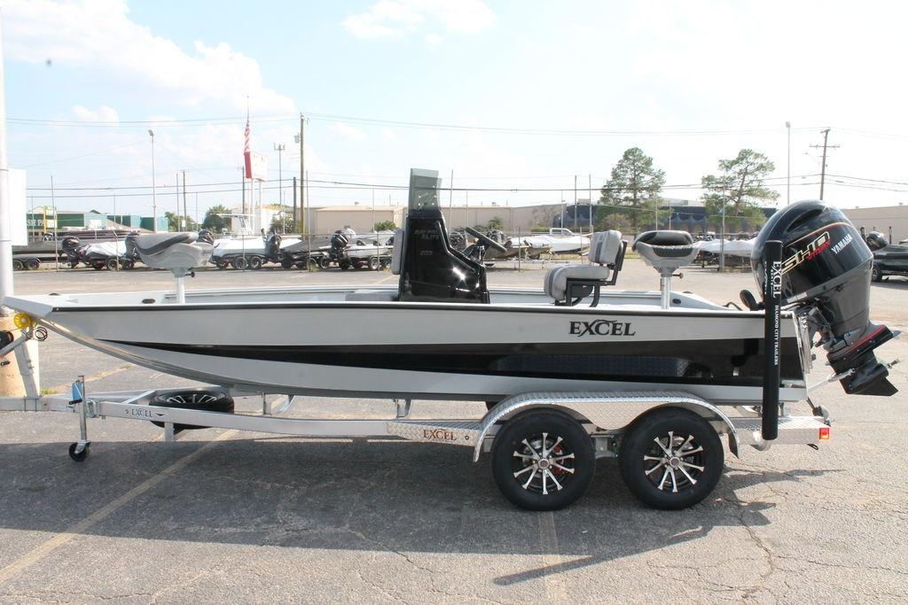 2026 Excel Bay Pro Elite 203 boat on trailer, side view, outdoors.