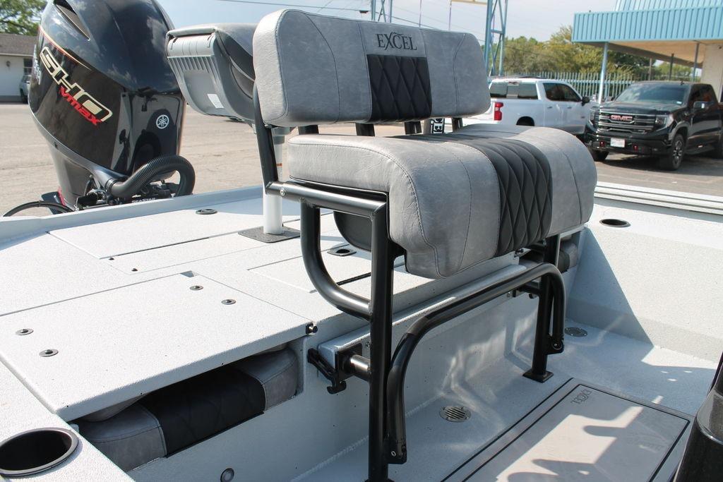 2026 Excel Bay Pro Elite 203 boat interior with cushioned seating and motor.