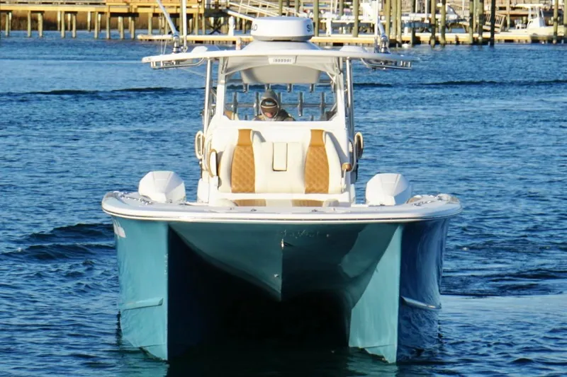  Yacht Photos Pics 2022 Tideline 365 Offshore boat cruising on calm blue water.