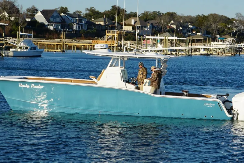  Yacht Photos Pics 2022 Tideline 365 Offshore boat on water near docks and houses.