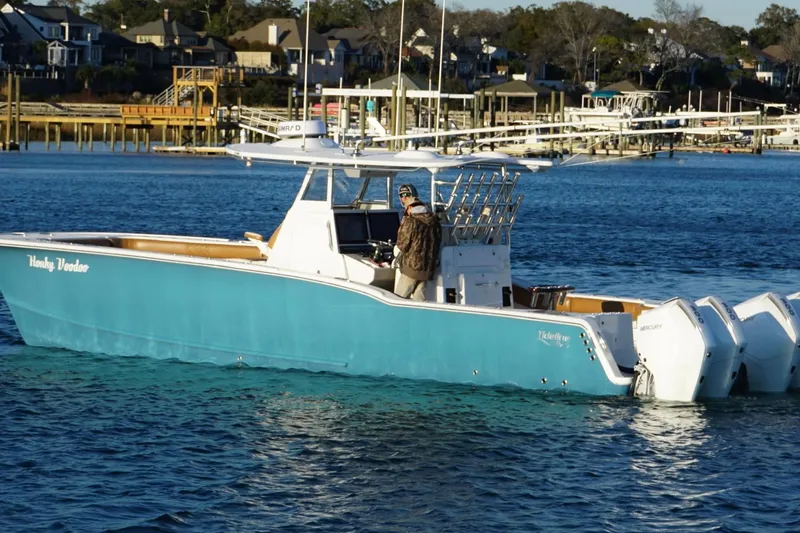  Yacht Photos Pics 2022 Tideline 365 Offshore boat on water near docks and houses.