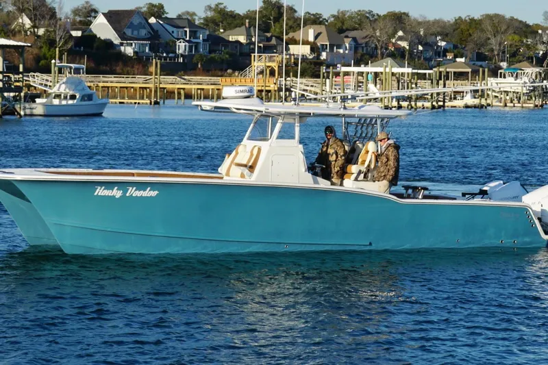  Yacht Photos Pics 2022 Tideline 365 Offshore boat on water, with two people onboard.
