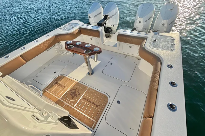  Yacht Photos Pics 2022 Tideline 365 Offshore boat with triple Mercury engines, spacious deck, and luxurious seating.