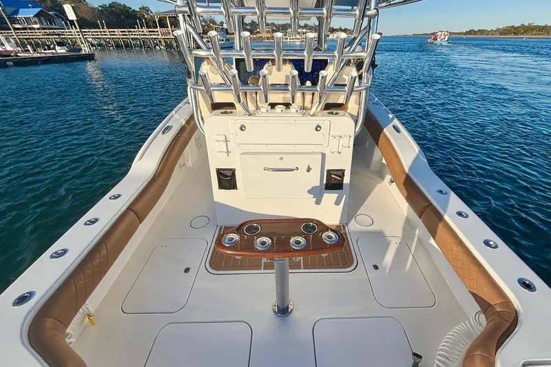  Yacht Photos Pics 2022 Tideline 365 Offshore boat interior with rod holders, on calm water.