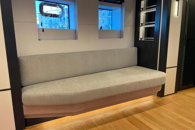  Yacht Photos Pics 2024 Explorer ICE interior with modern gray sofa and wooden flooring.