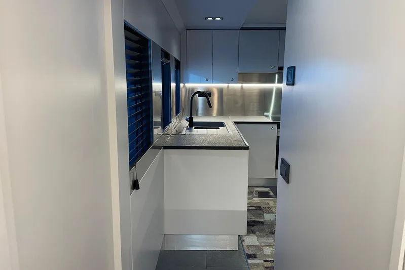  Yacht Photos Pics Modern kitchen interior in 2024 Explorer ICE, featuring sleek cabinetry and stainless steel accents.