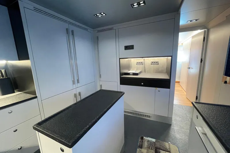  Yacht Photos Pics Modern kitchen interior in 2024 Explorer ICE model, featuring sleek cabinetry and minimalist design.