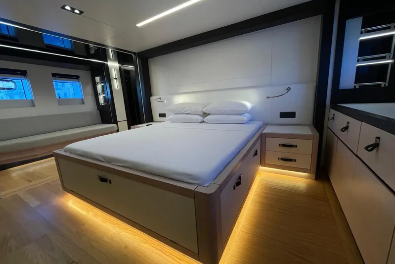  Yacht Photos Pics Luxurious 2024 Explorer ICE bedroom with modern design, ambient lighting, and sleek furnishings.