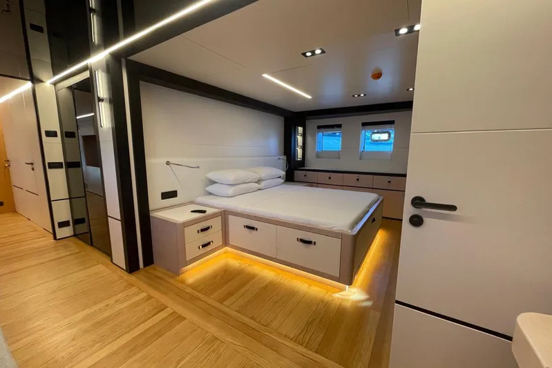  Yacht Photos Pics Luxurious 2024 Explorer ICE bedroom with modern design, ambient lighting, and wooden flooring.