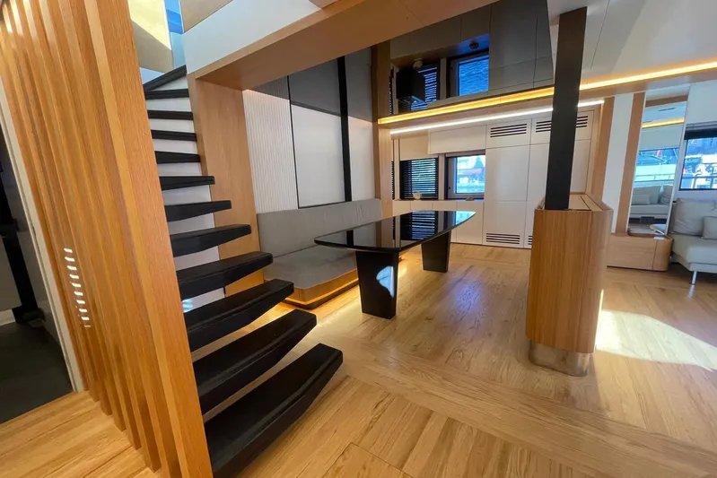  Yacht Photos Pics Modern interior of 2024 Explorer ICE yacht with sleek staircase and elegant dining area.