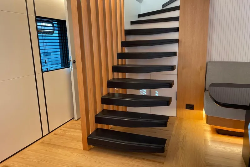  Yacht Photos Pics Modern interior of 2024 Explorer ICE with sleek wooden staircase and ambient lighting.