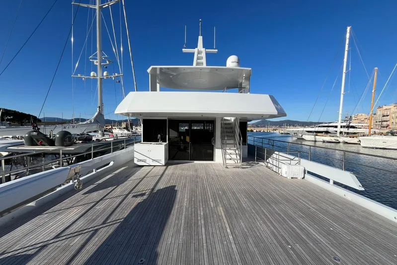  Yacht Photos Pics 2024 Explorer ICE yacht deck with marina view, featuring sleek design and clear blue sky.