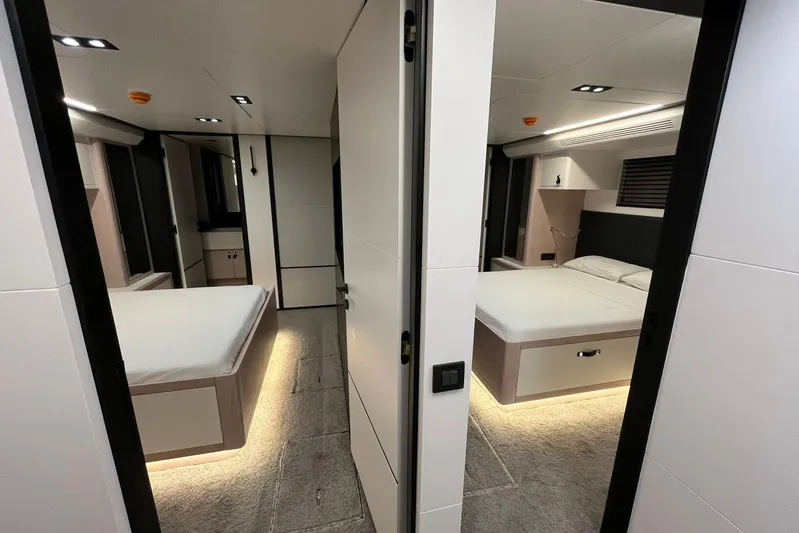  Yacht Photos Pics Luxurious 2024 Explorer ICE interior with modern twin bedrooms and ambient lighting.