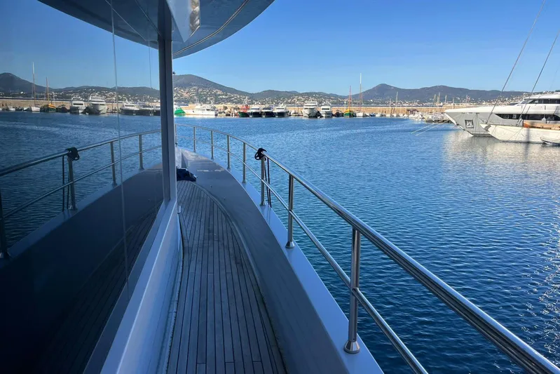  Yacht Photos Pics 2024 Explorer ICE yacht docked in a scenic marina with mountain views.