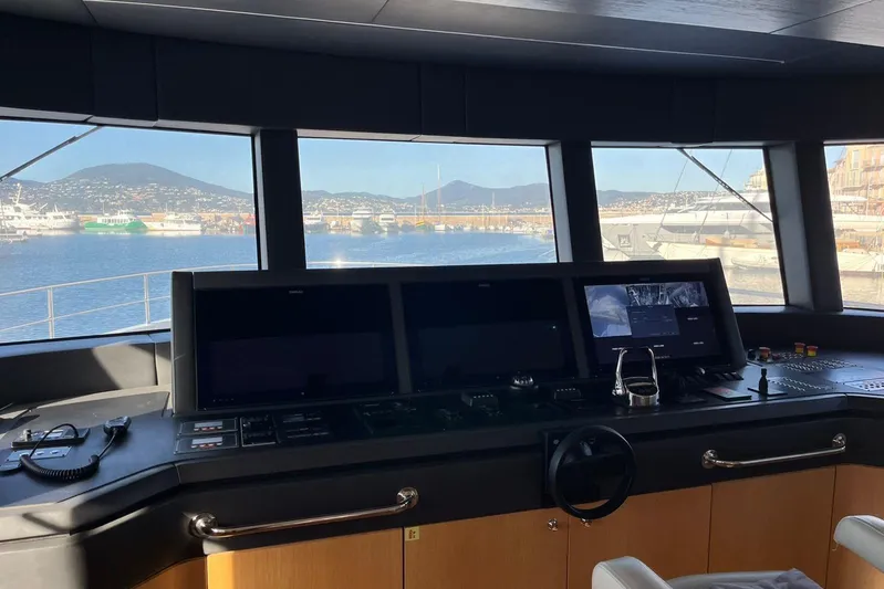  Yacht Photos Pics Bridge of 2024 Explorer ICE yacht with navigation screens and harbor view.