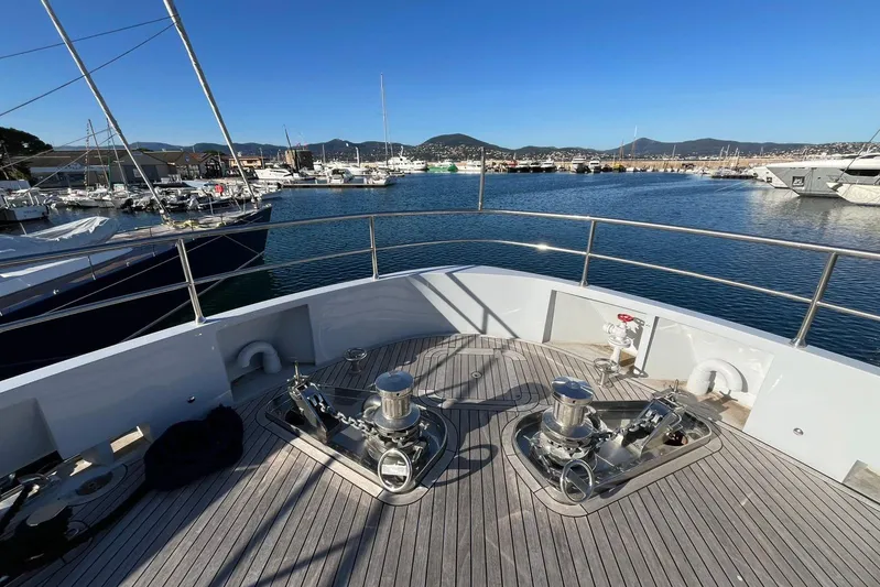  Yacht Photos Pics Bow of 2024 Explorer ICE yacht in marina, showcasing deck equipment and scenic harbor view.