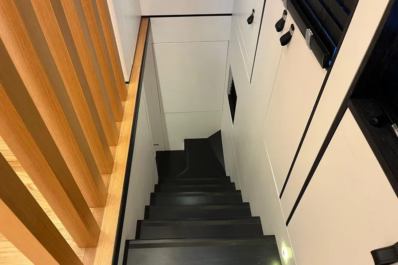  Yacht Photos Pics Modern interior staircase in 2024 Explorer ICE, featuring sleek design and wooden accents.