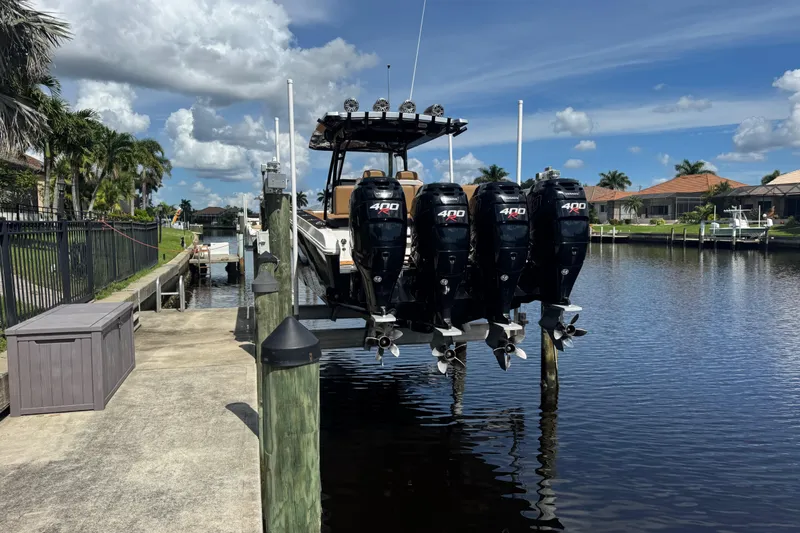  Yacht Photos Pics 2020 Fountain 38 Center Console boat with four powerful outboard engines docked by a canal.
