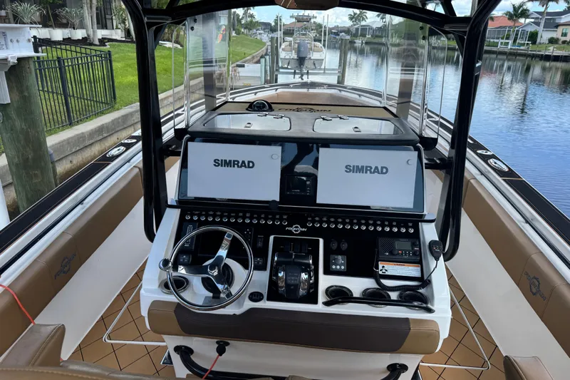  Yacht Photos Pics 2020 Fountain 38 Center Console boat interior with dual Simrad displays and steering wheel.