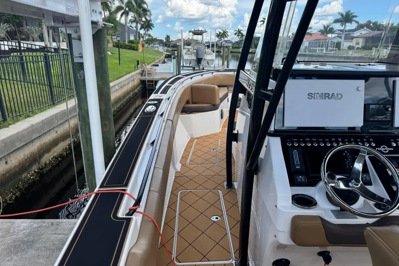  Yacht Photos Pics 2020 Fountain 38 Center Console boat docked, featuring Simrad navigation system and luxurious seating.